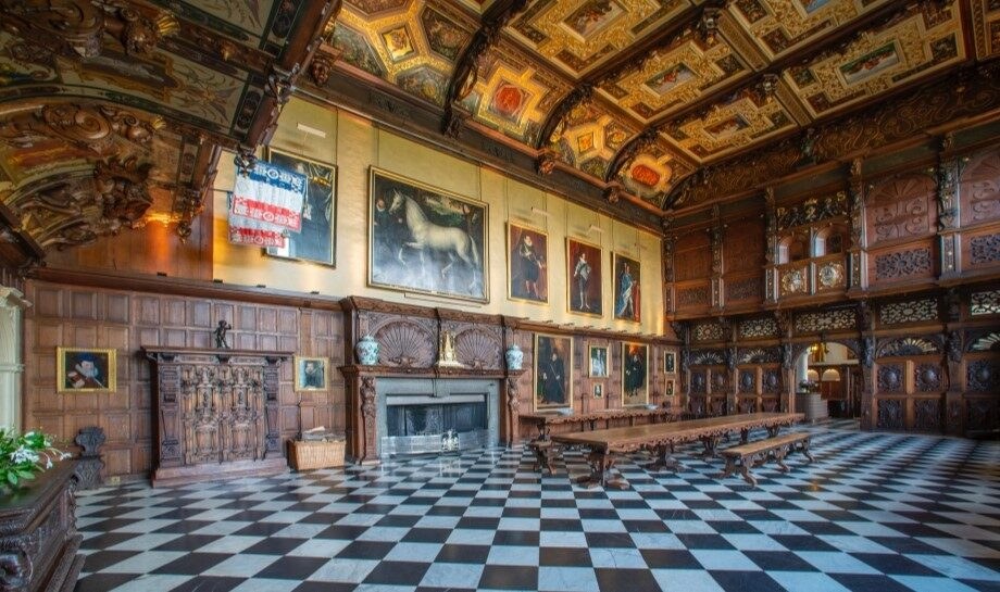 The Marble Hall at Hatfield House, with its long table and chequerboard floor